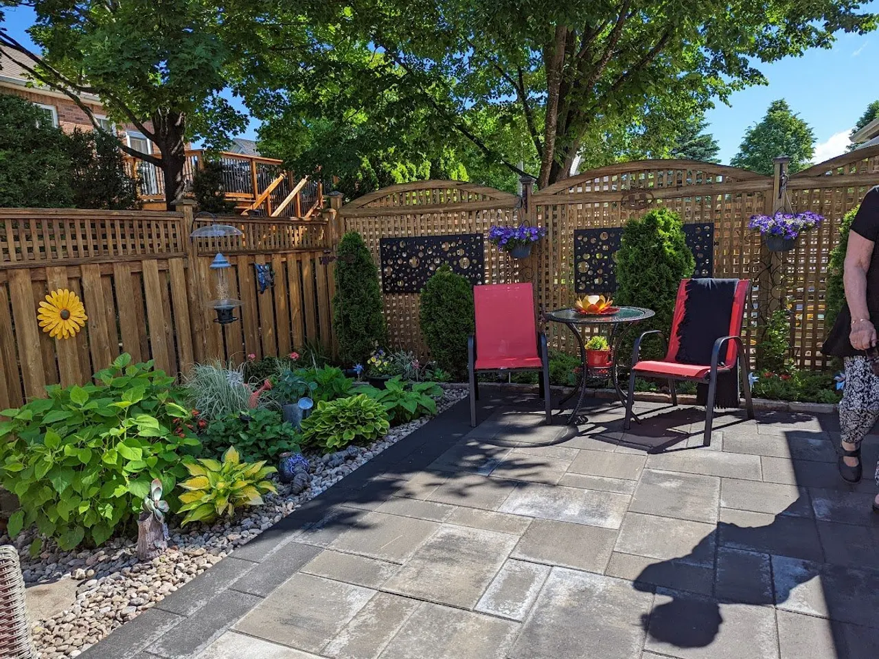 Backyard patio with mixed perennial beds in Pakenham by ALM Construction